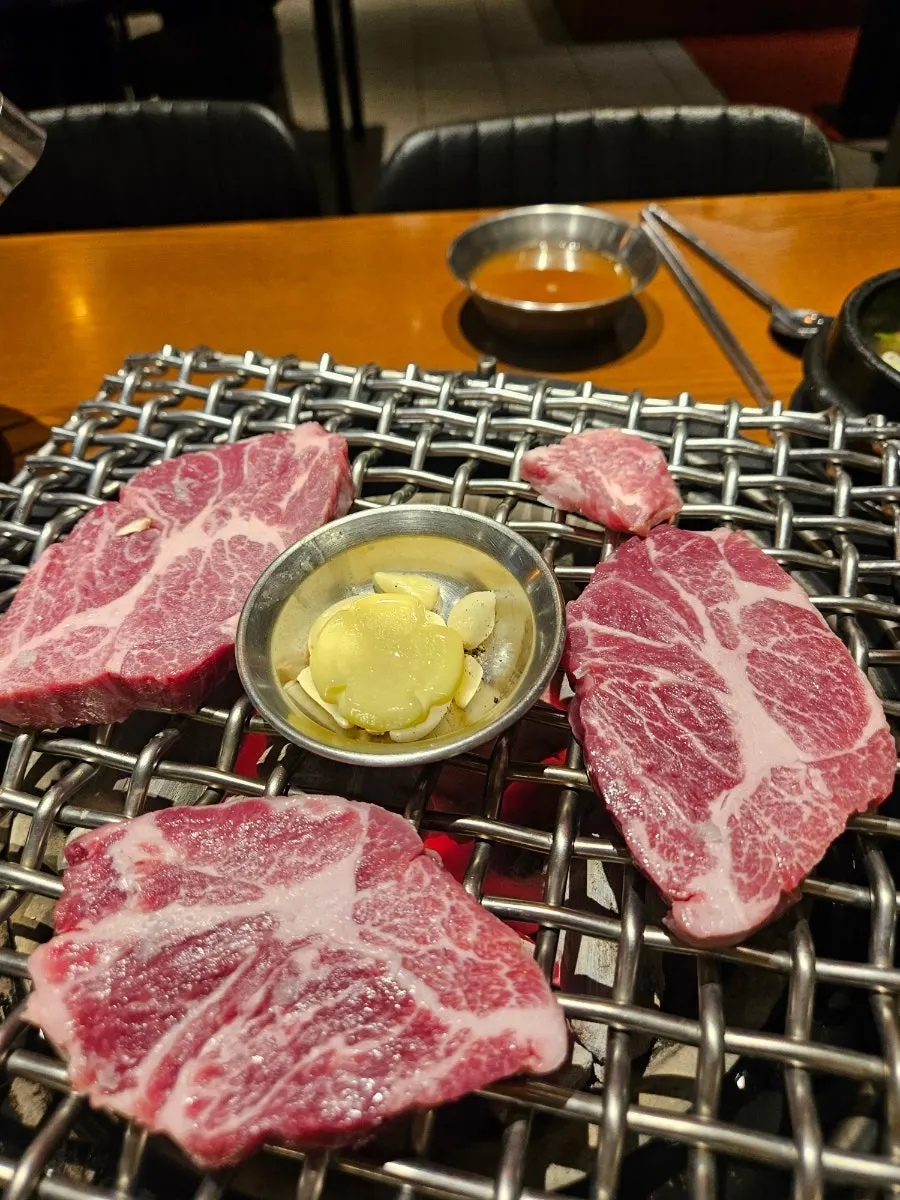 A full dinner spread of meat and doenjang jjigae