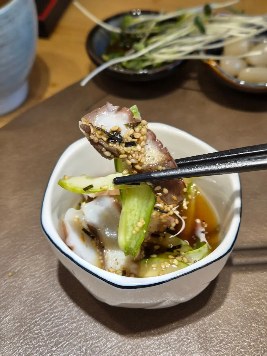 A plate of white fish sashimi from the course