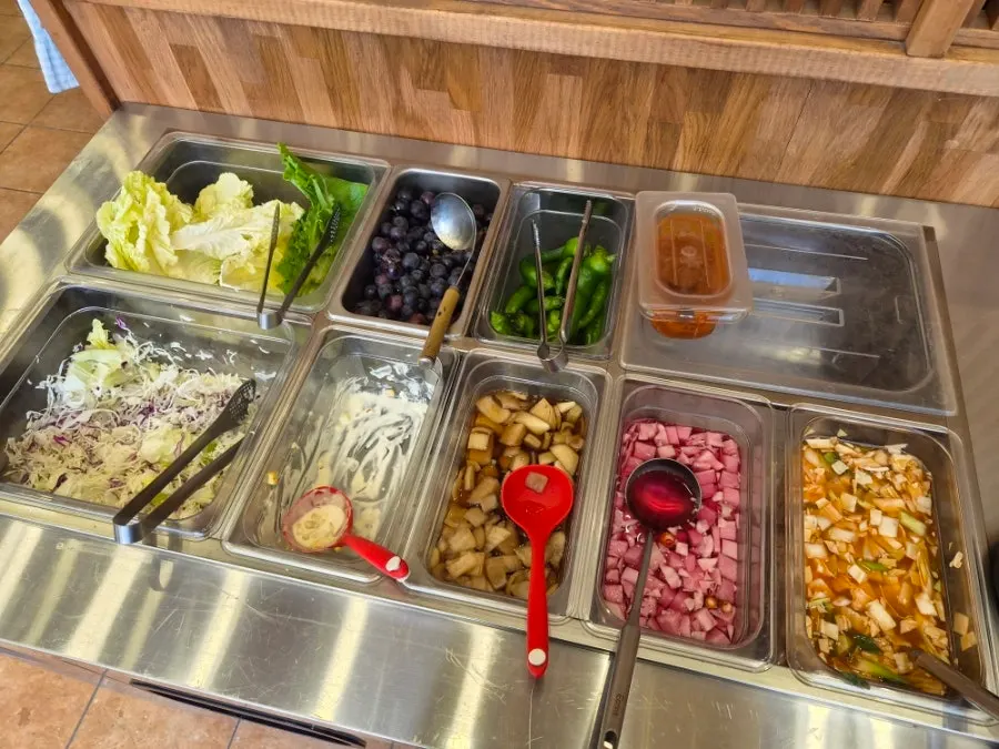 Self-serve banchan corner with salad and lettuce wraps at Oneul Haru
