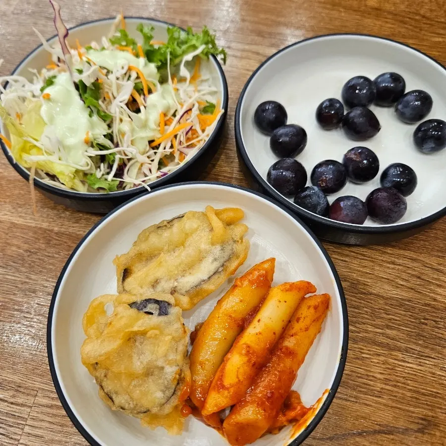 Plate of tteokbokki and fried snacks from the self-serve bar