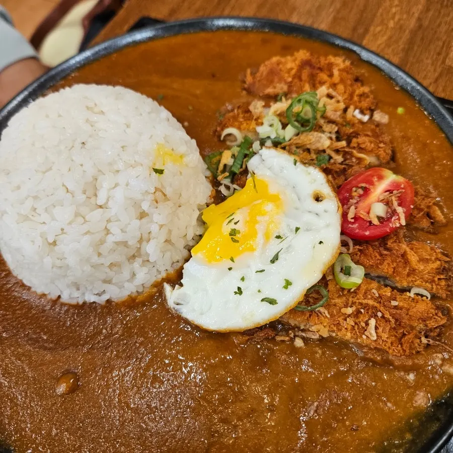 A piece of pork cutlet dipped in curry