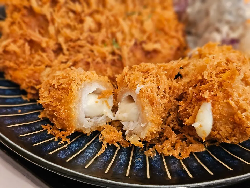 Cheese roll served next to pork cutlet sauce