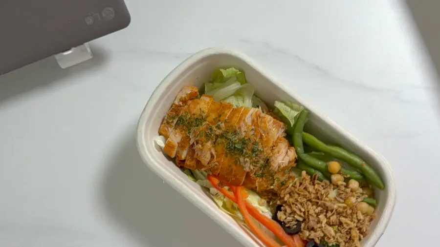 Chicken breast piled generously on top of vegetables