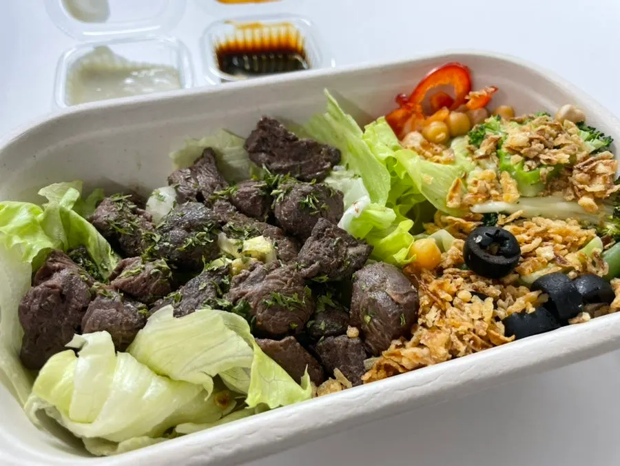 Protein box topped with chunky cut beef
