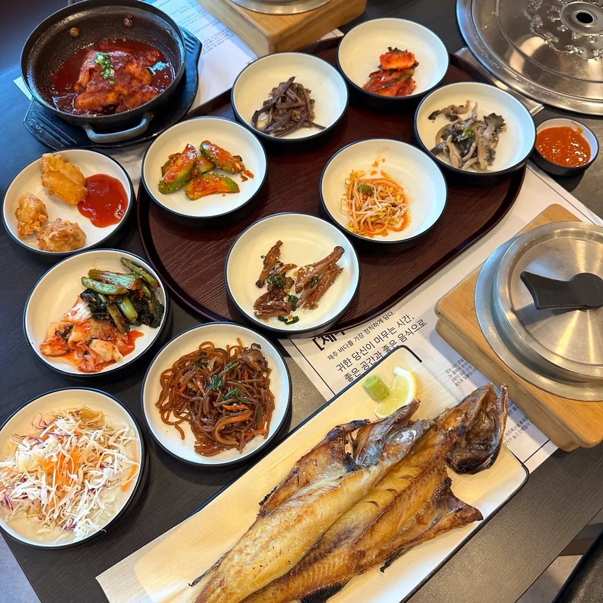 A full table spread with grilled atka mackerel and boneless hairtail stew