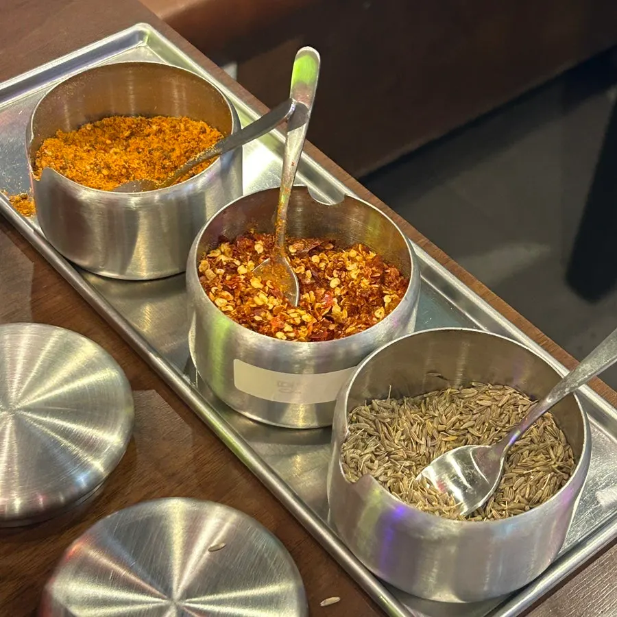 Jeeran and cumin seasoning jars set on the table