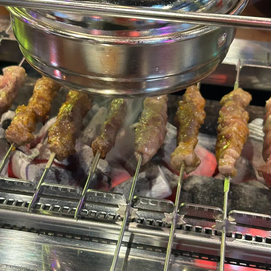 A thick, well-grilled lamb skewer