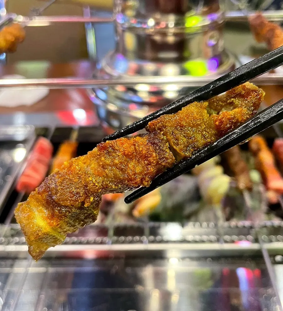 Lamb skewers turning golden as they cook