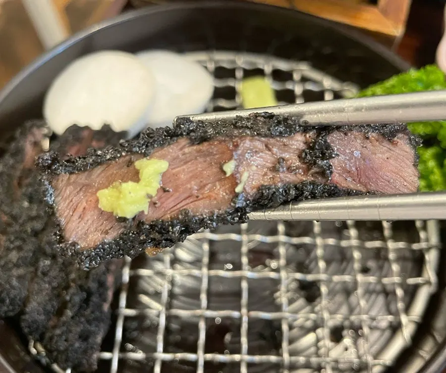 Black gyukatsu cooking on the grill