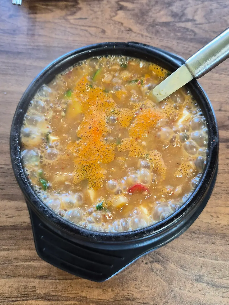 Complimentary cheonggukjang packed with ingredients