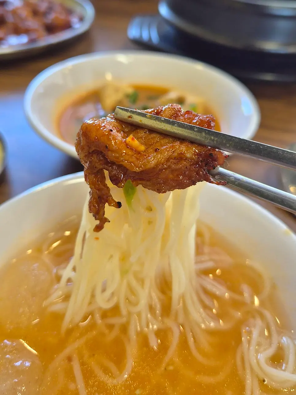Kimchi noodle dish served alongside gochujang-grilled pork