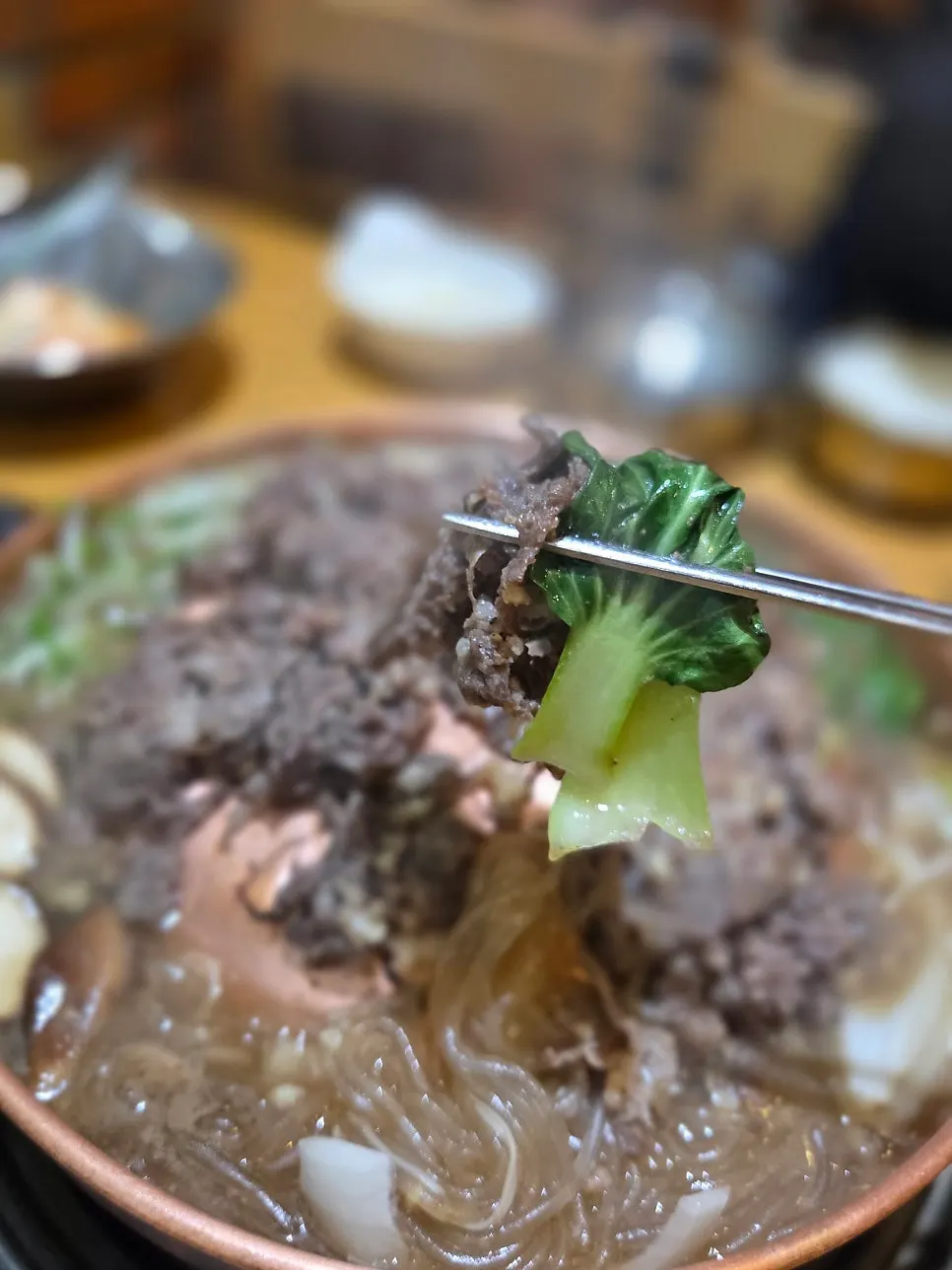 Glass noodles and bulgogi in the boiling broth