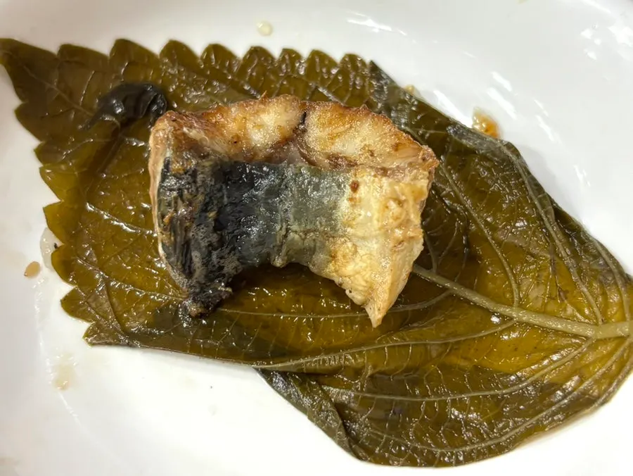 Grilled eel served on a pickled perilla leaf