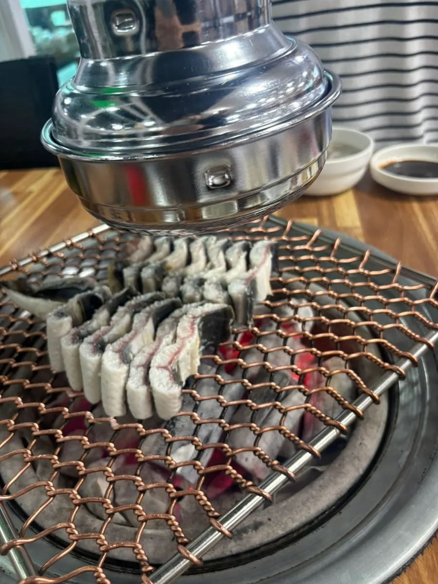 Thick eel cooking on the grill