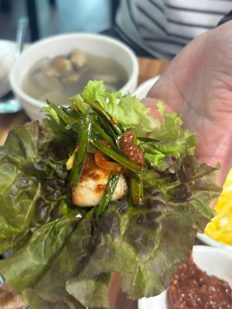 A piece of eel placed on a lettuce leaf