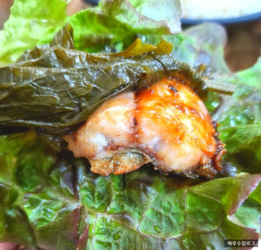 A piece of eel wrapped in lettuce