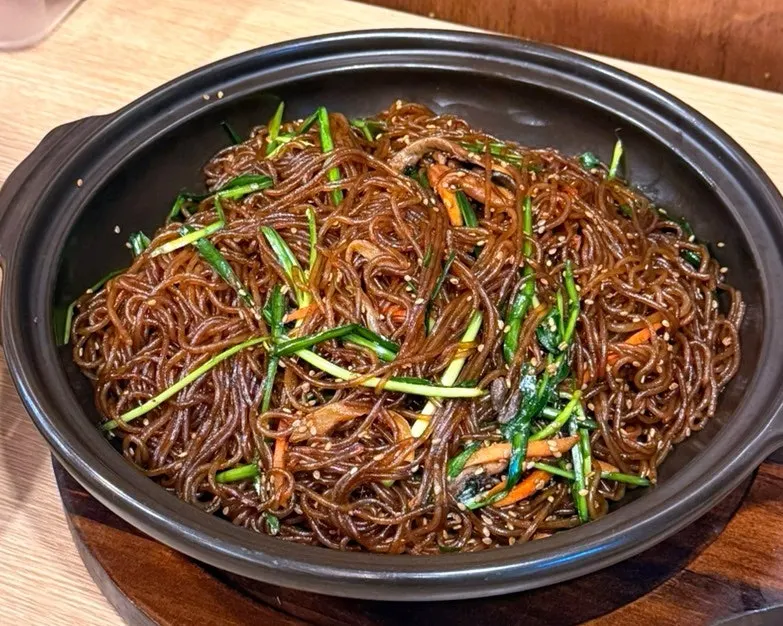 Crispy chicken and japchae side dishes