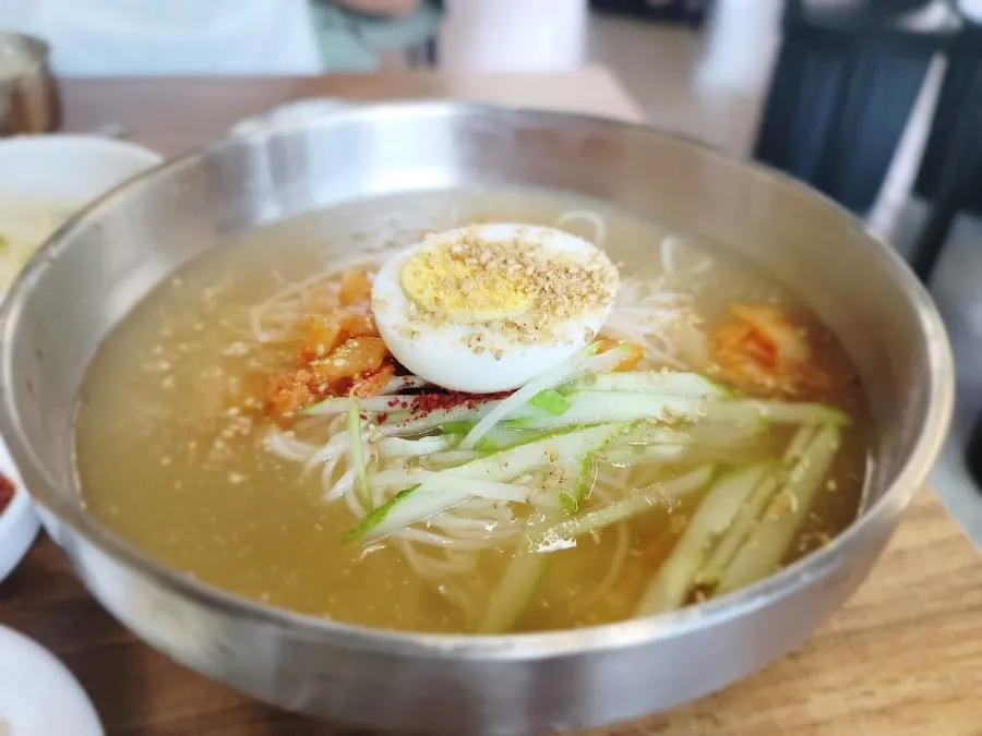 Kimchi noodle soup with floating ice crystals