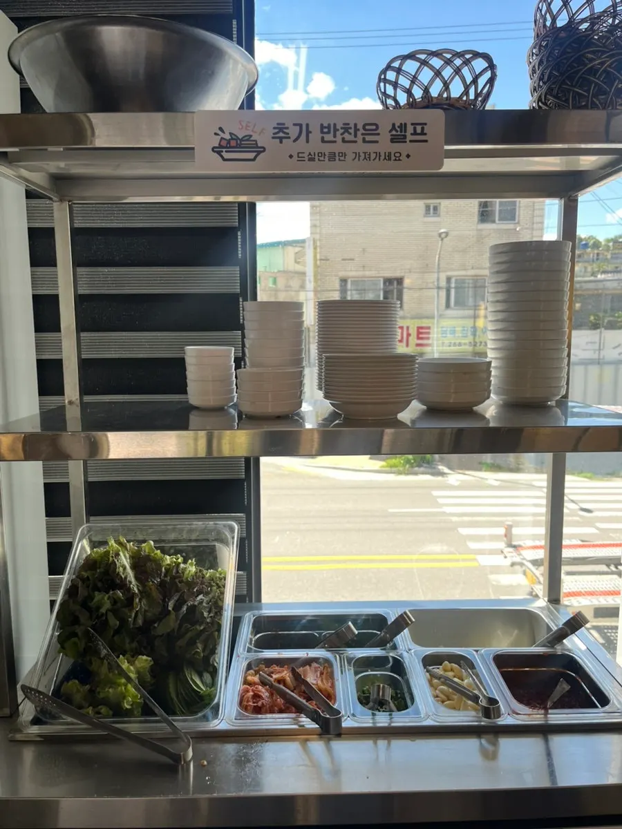 Ttukbangjip's side dishes including scallion salad and radish pickles