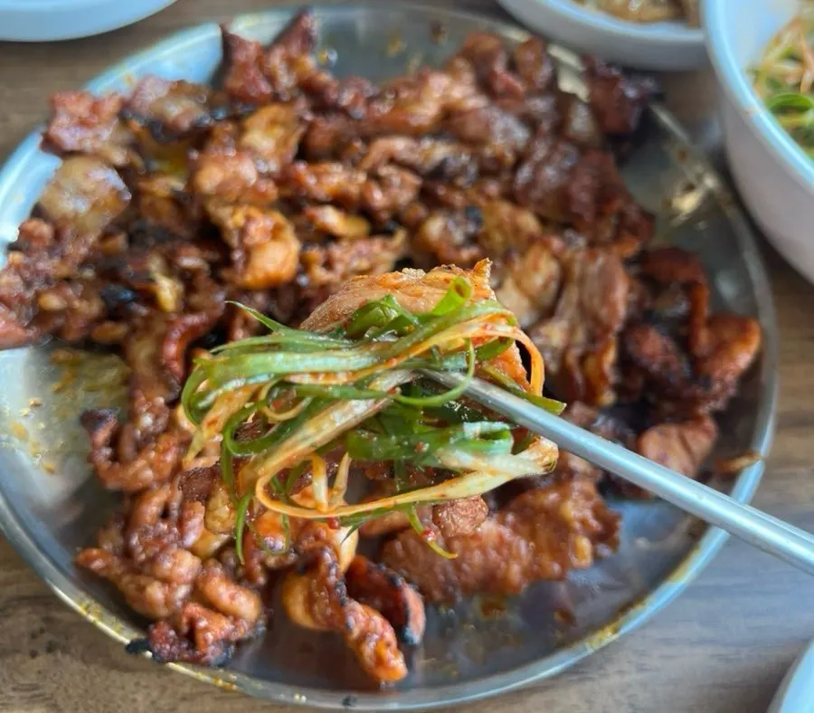 Gochujang pork eaten with a bowl of rice