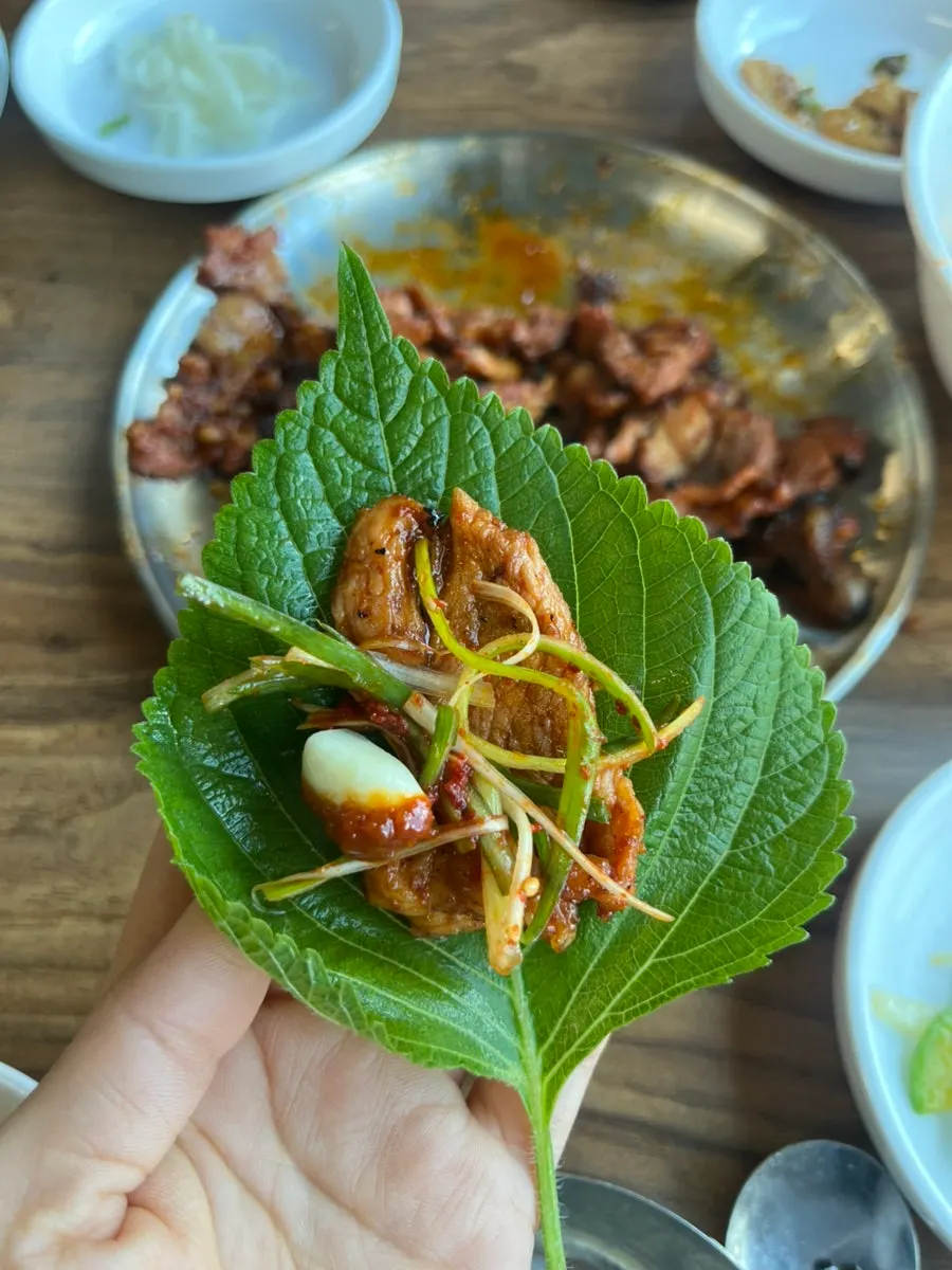 Charcoal gochujang pork wrapped in a perilla leaf
