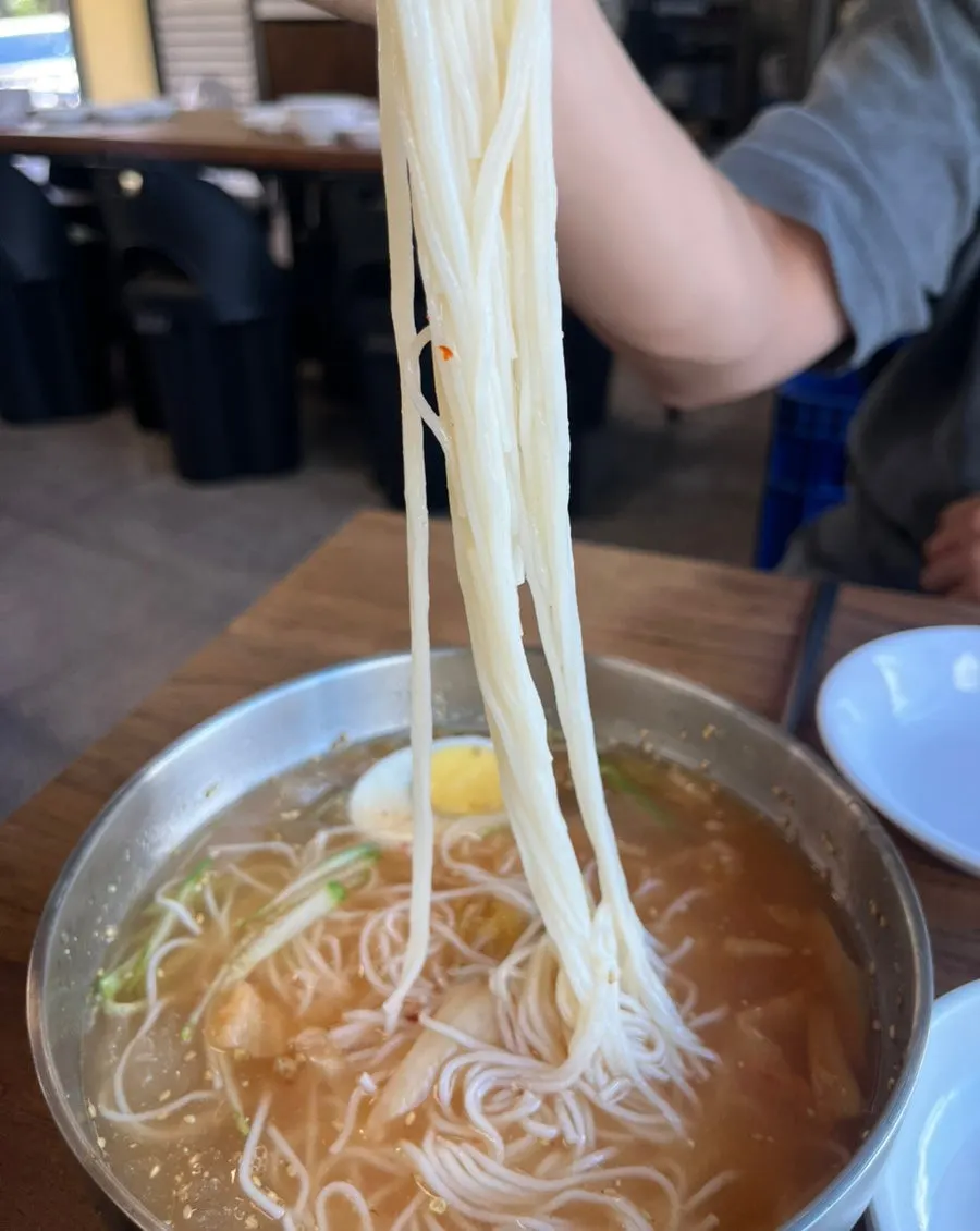 Kimchi-rolled noodles with white broth