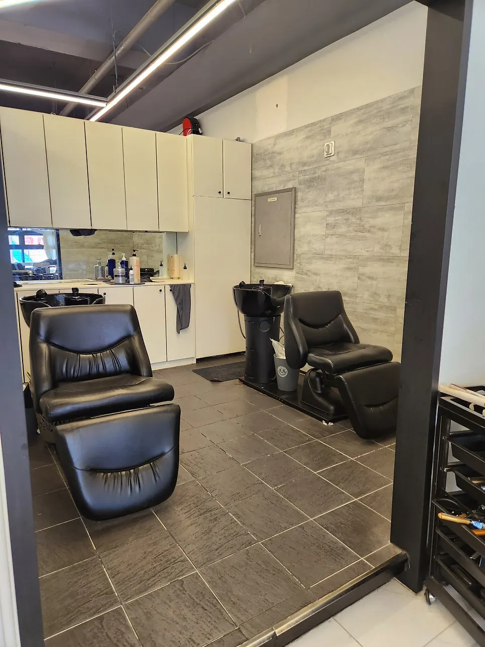 Salon interior with large windows and wood furniture