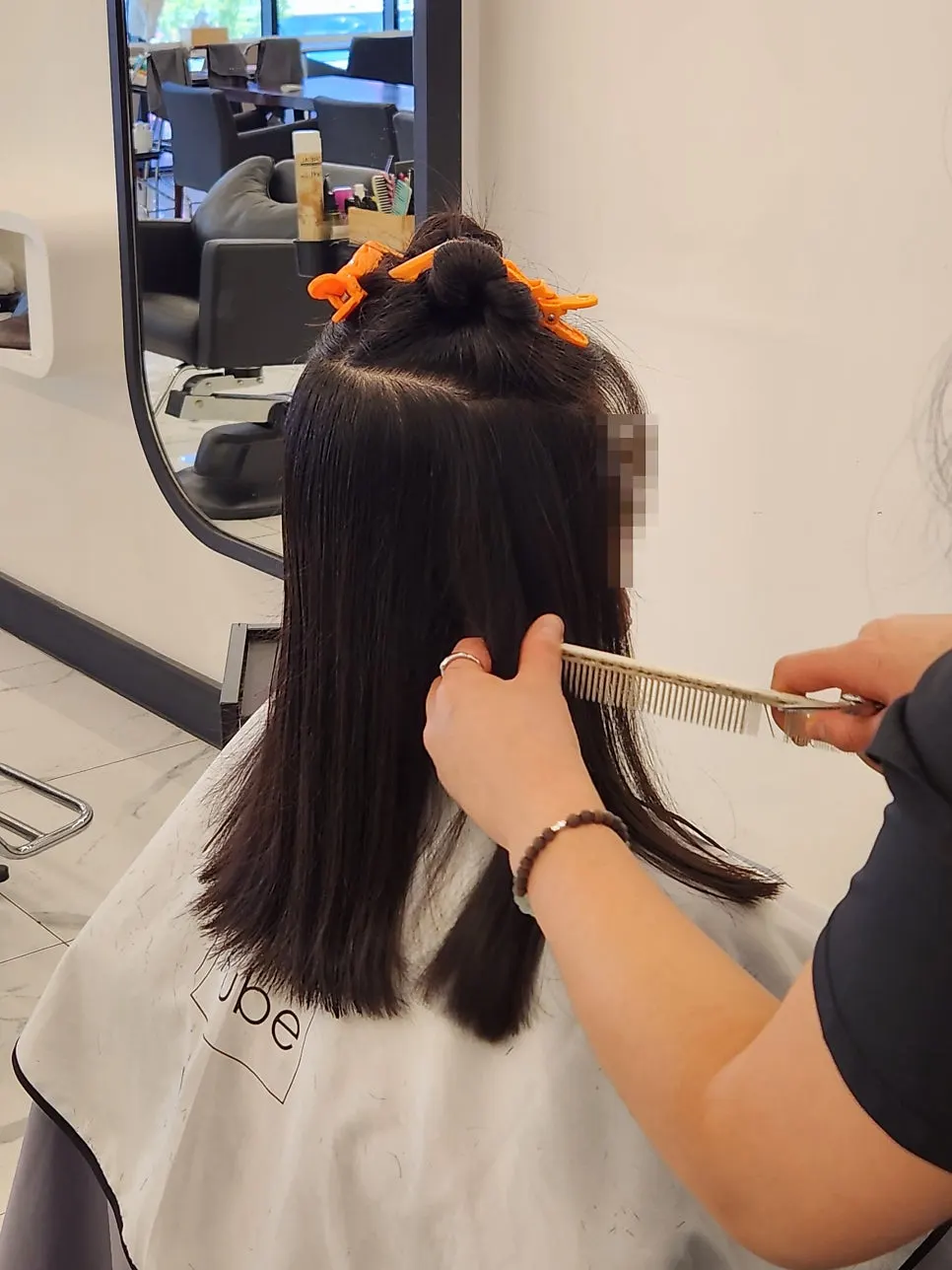 Medium-length hair falling just above the chest before service
