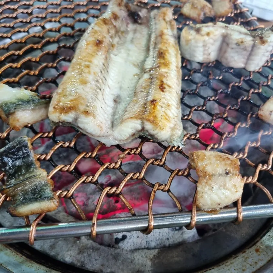 Eel on the charcoal grill with side dishes