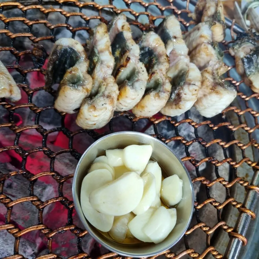 Eel sushi topped with wasabi and roasted garlic