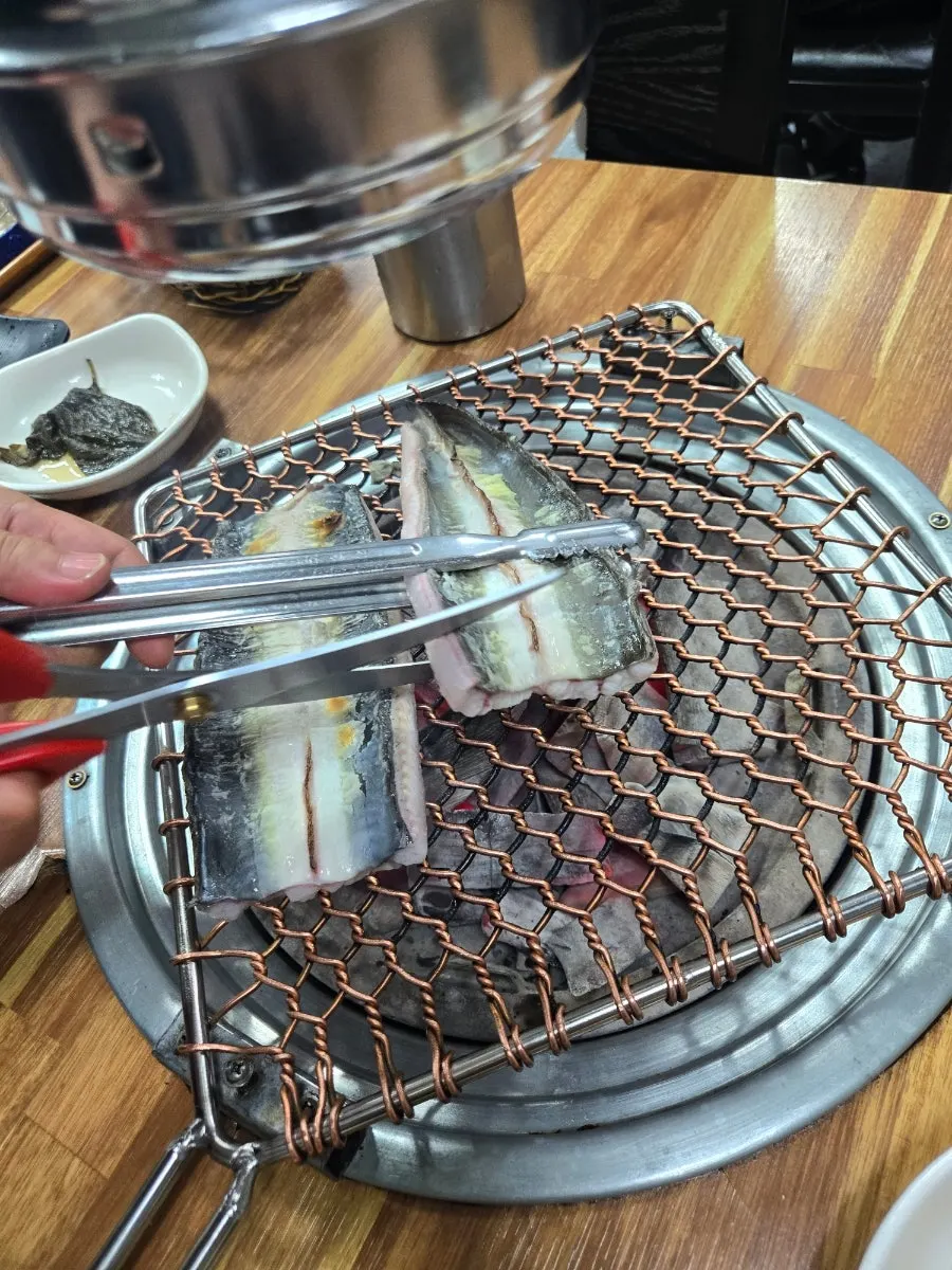 Eating the grilled eel with side dishes
