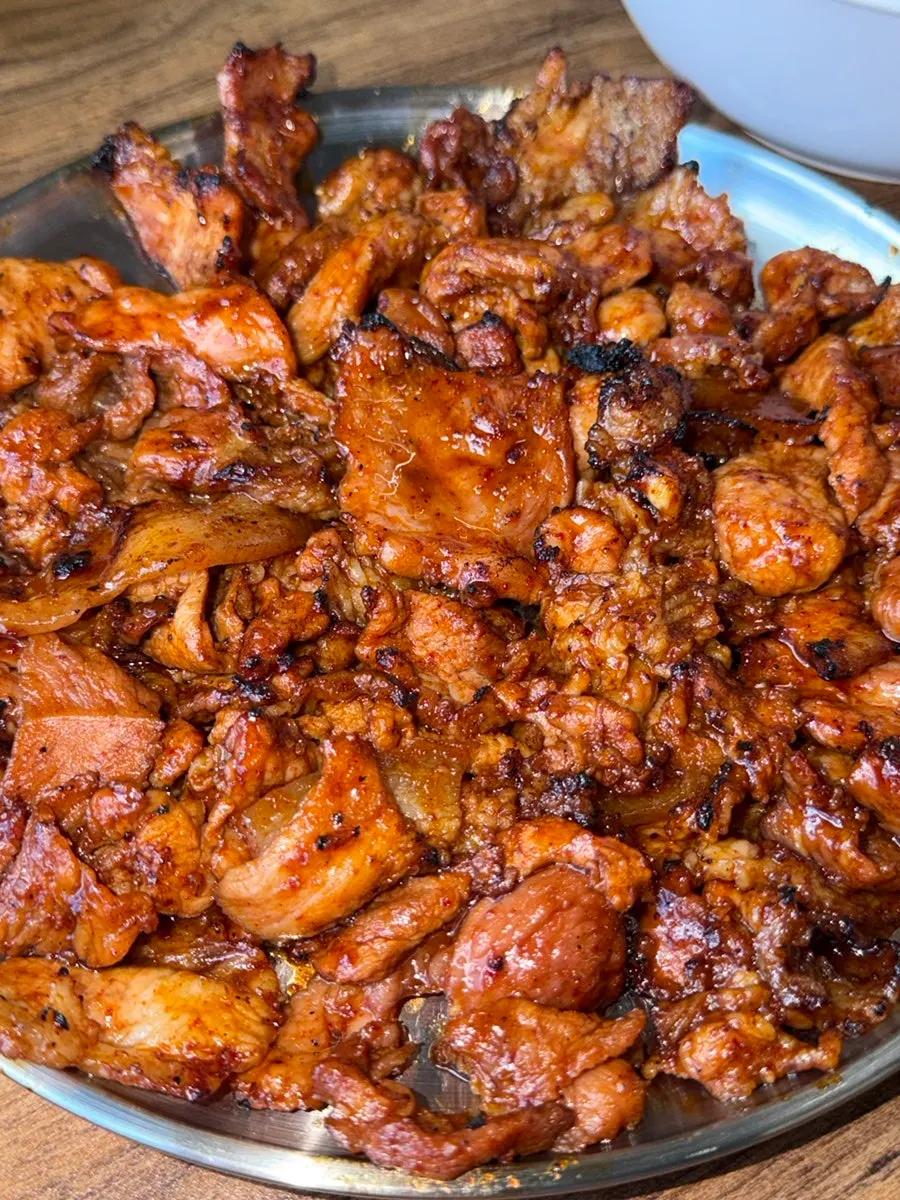 Plate of charcoal gochujang pork grilled to just the right doneness
