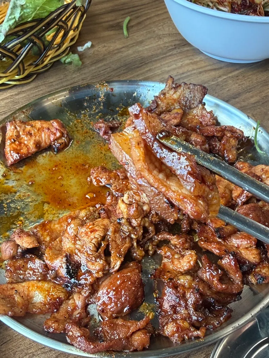 Charcoal gochujang pork served with green onion salad