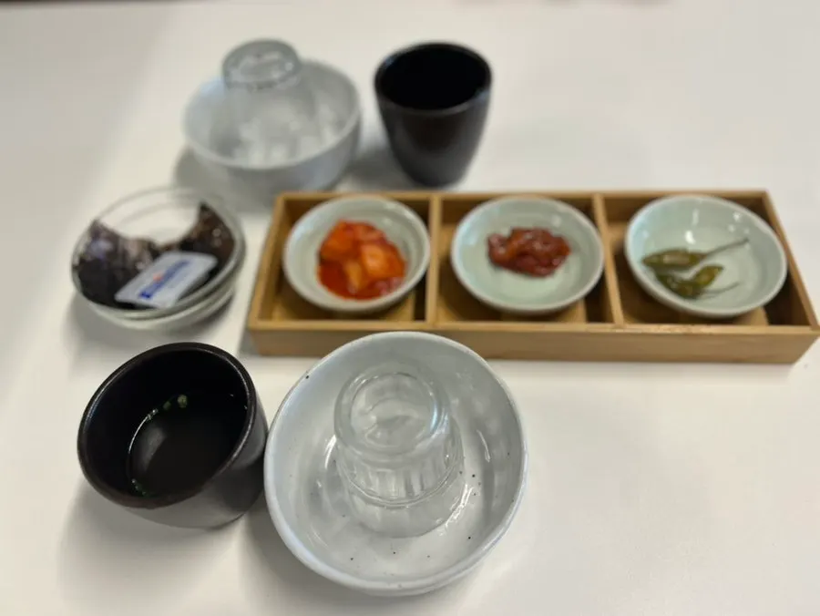 Table set with basic side dishes and a personal water bottle