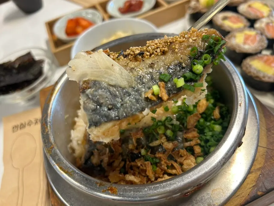 Freshly cooked rice mixed with mackerel in the pot
