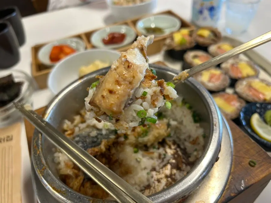 A bite of mackerel pot rice wrapped in seaweed