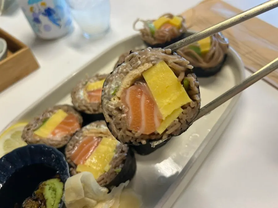 Plate of salmon buckwheat gimbap showing the cut cross-section