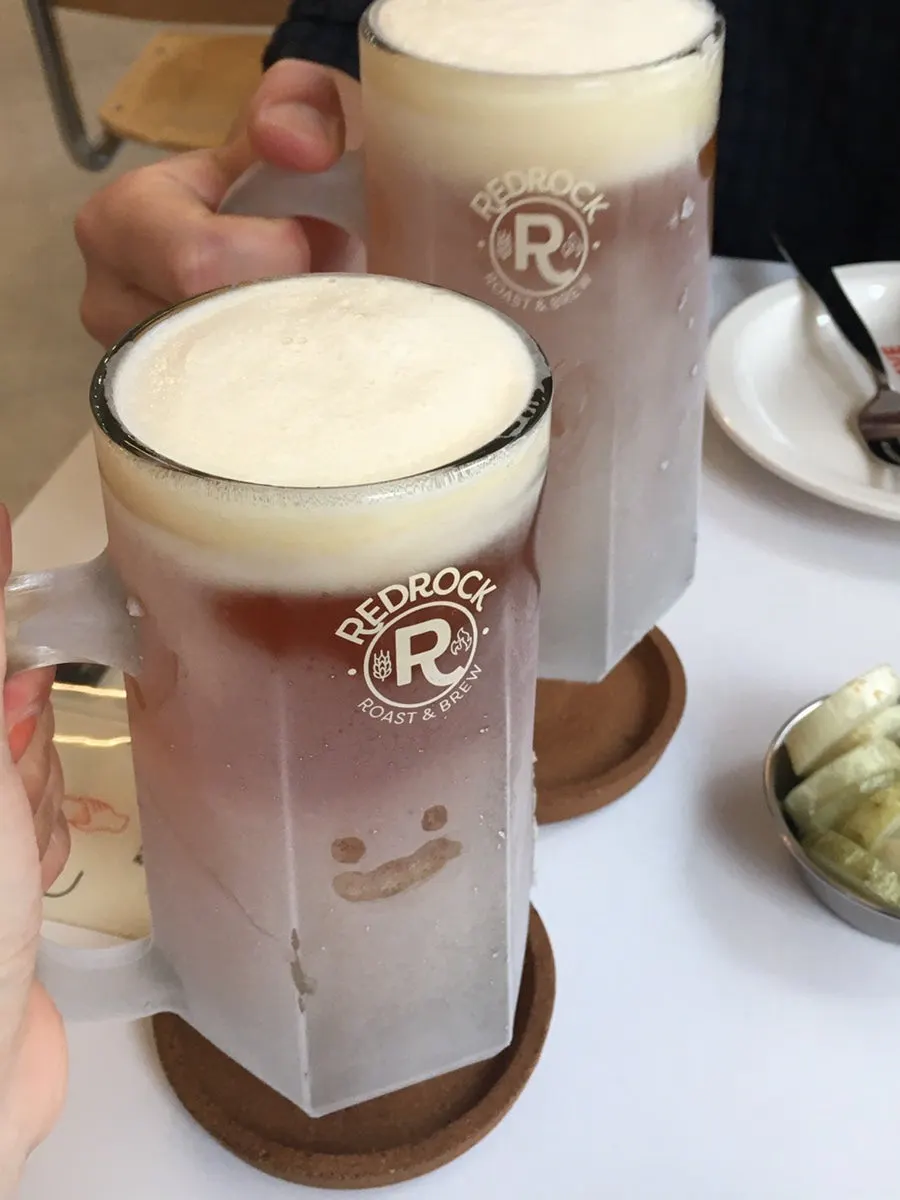 Two foamy glasses of Red Rock draft beer