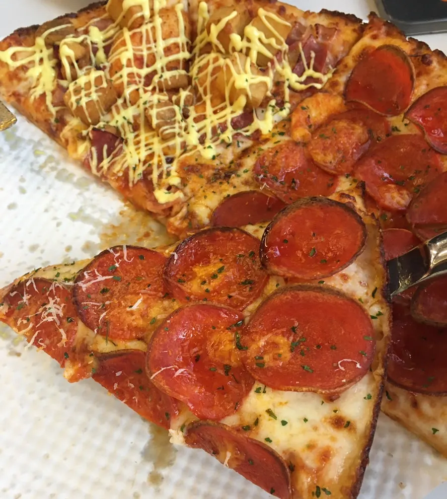 A slice of pepperoni pizza