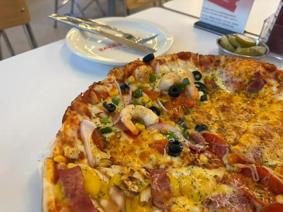 Pizza and drinks set on the table