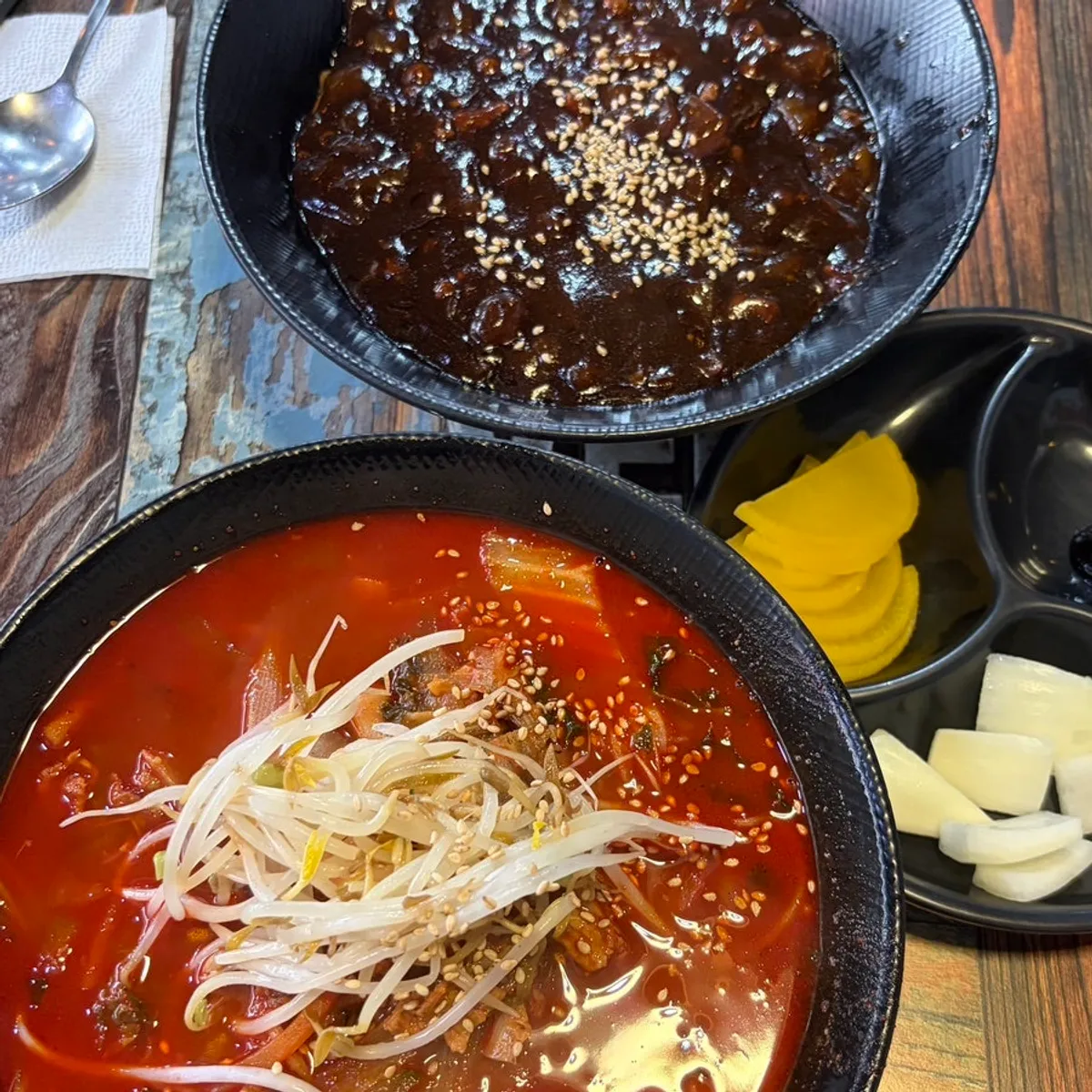 Table set with jjamppong, ulzzajang, and mini glutinous sweet-and-sour pork