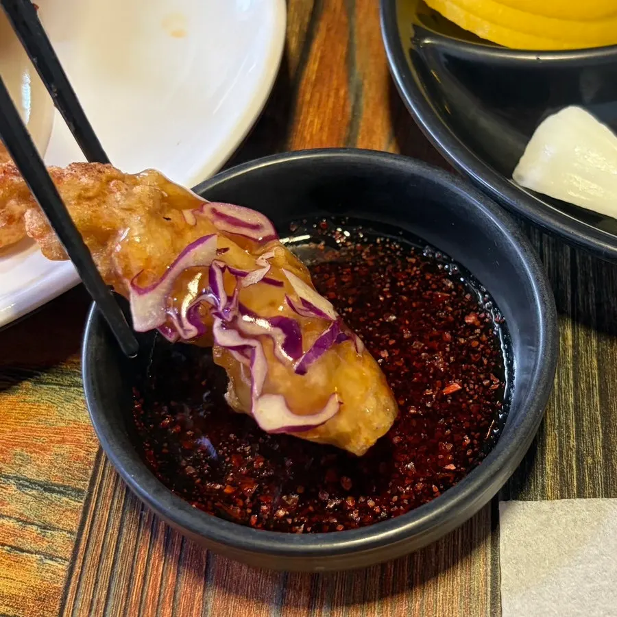 Mini glutinous sweet-and-sour pork with sauce poured over it