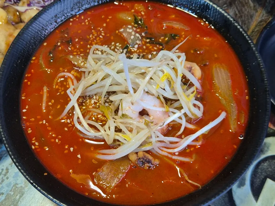 Bowl of jjamppong topped with seafood