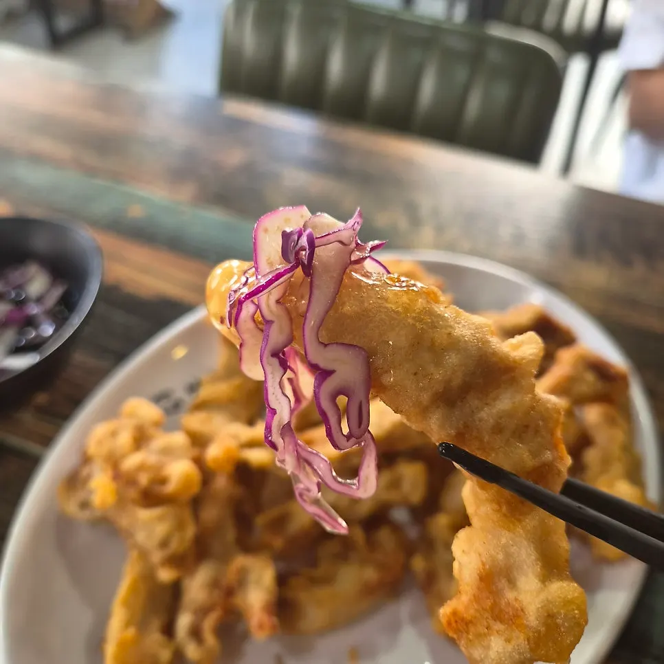 Dipping a piece of tangsuyuk into the sauce