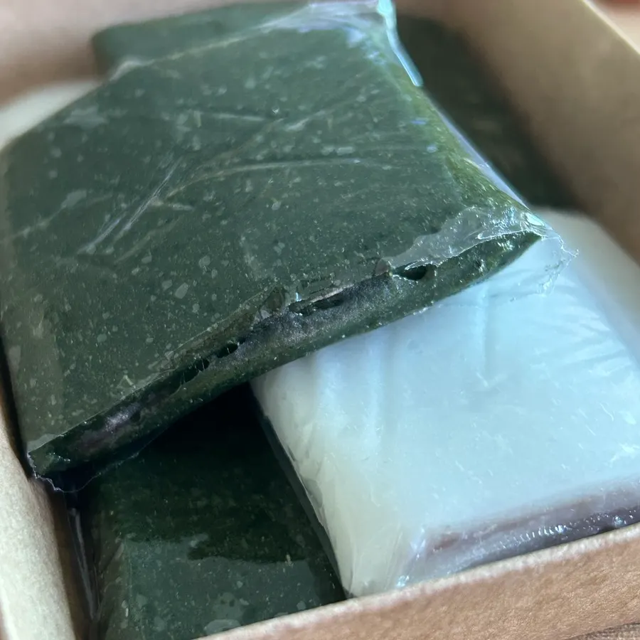 Cross-section of anggojeolpyeon with red bean paste filling between rice cake layers
