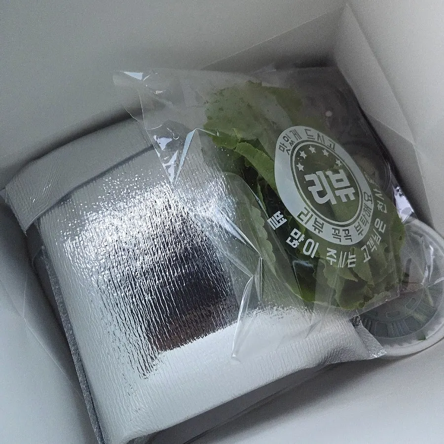 Jokbal takeout packed in a black shopping bag