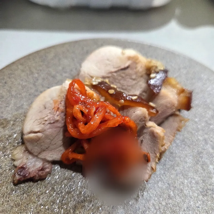 A piece of original jokbal topped with dried radish strips