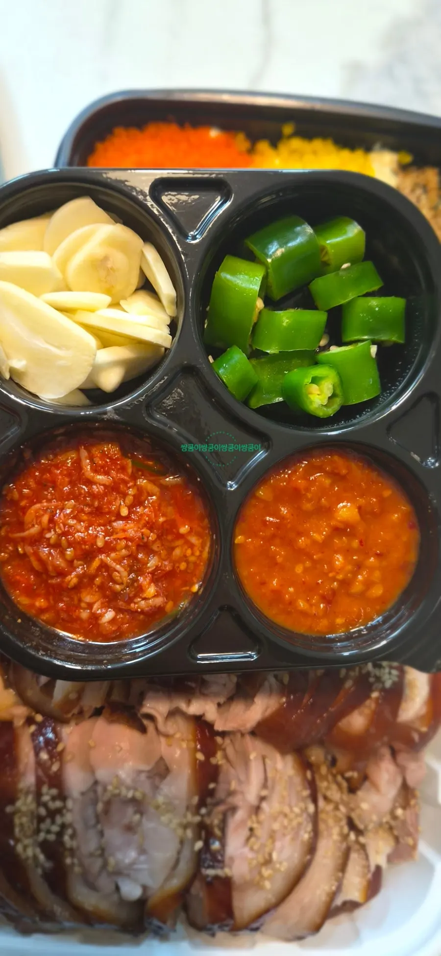 Cheongmigwan takeout side dishes set up on a home table