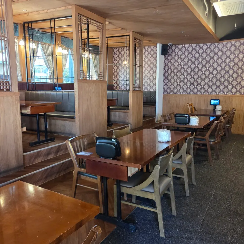 Interior with chandelier lighting and wood-toned furniture
