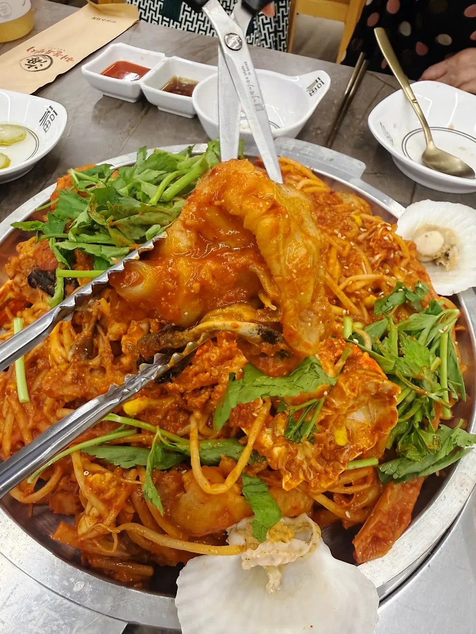 Hot-plate monkfish seafood stew topped with large octopus